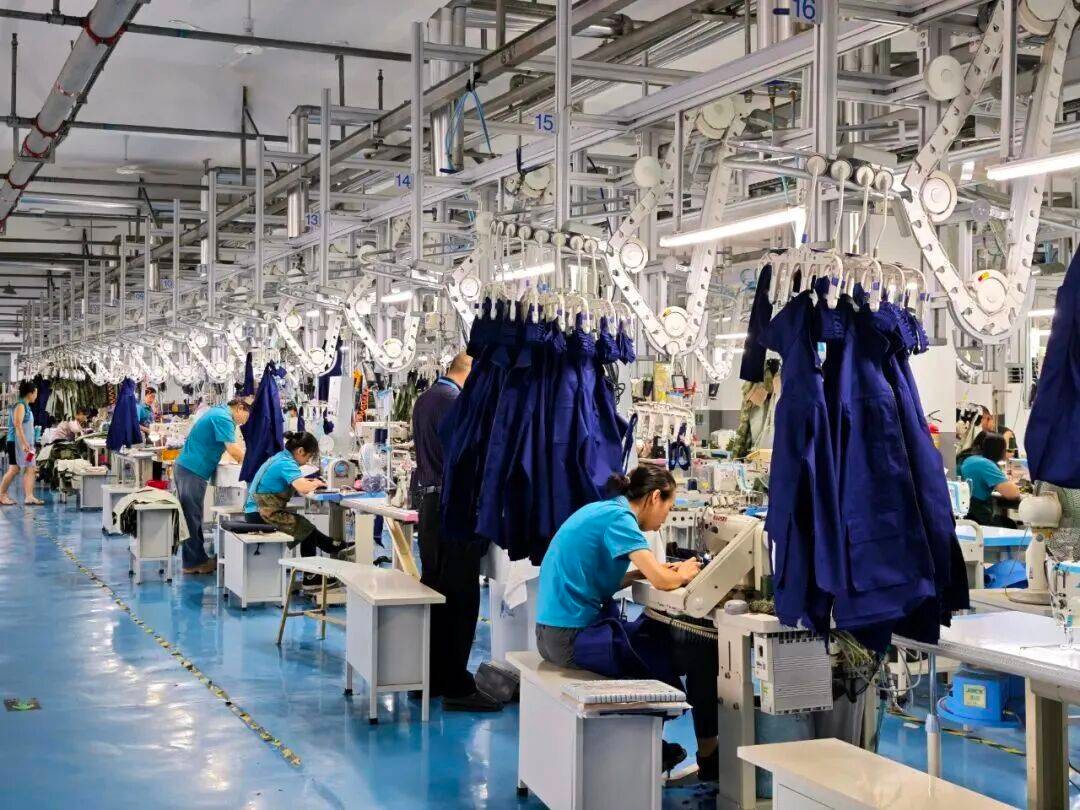 Workers operating garment sewing line